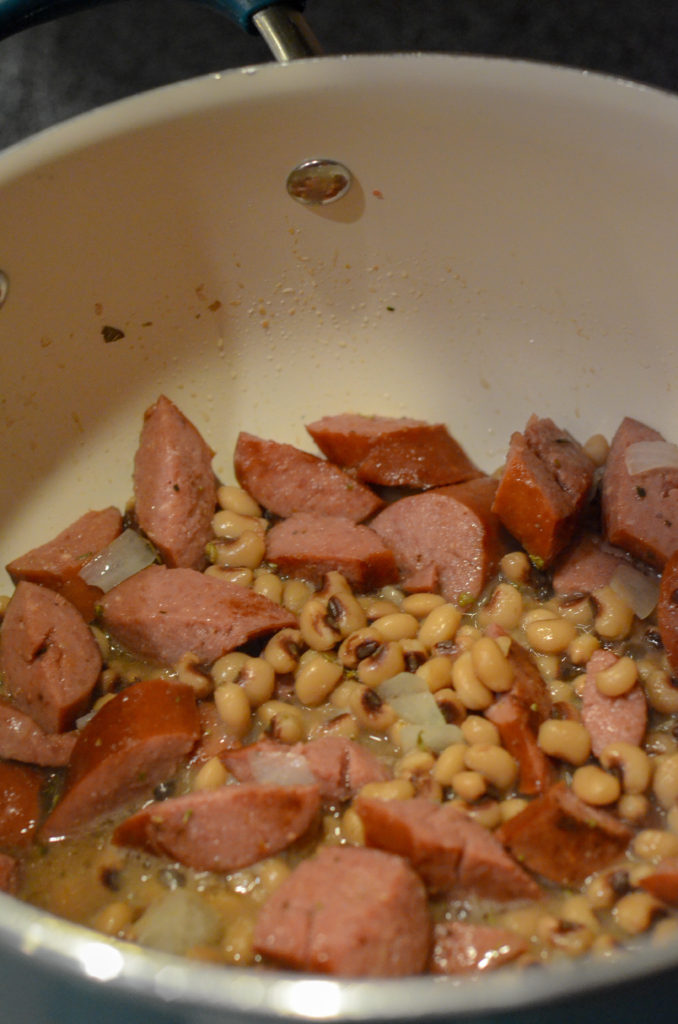 sausage and purple hull peas in pot for a purple hull pea recipe