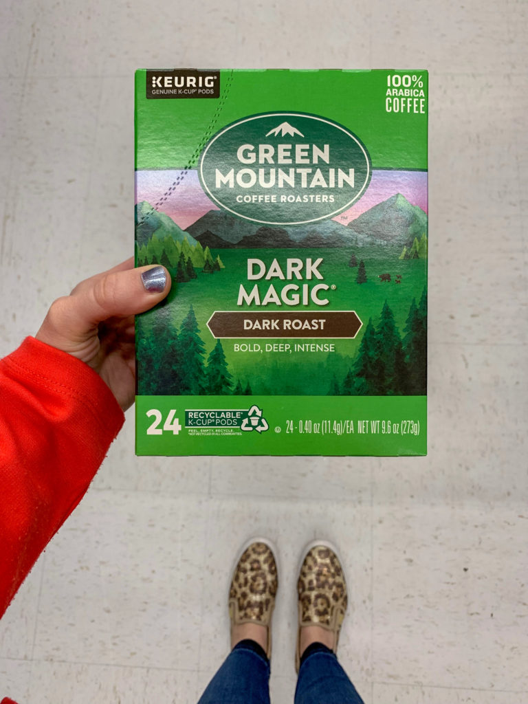 woman holds Green Mountain Roasted Coffee box in hand at Walmart
