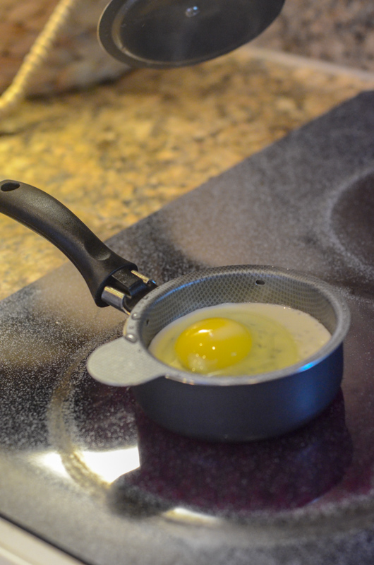egg cooks on stove in egg poacher skillet
