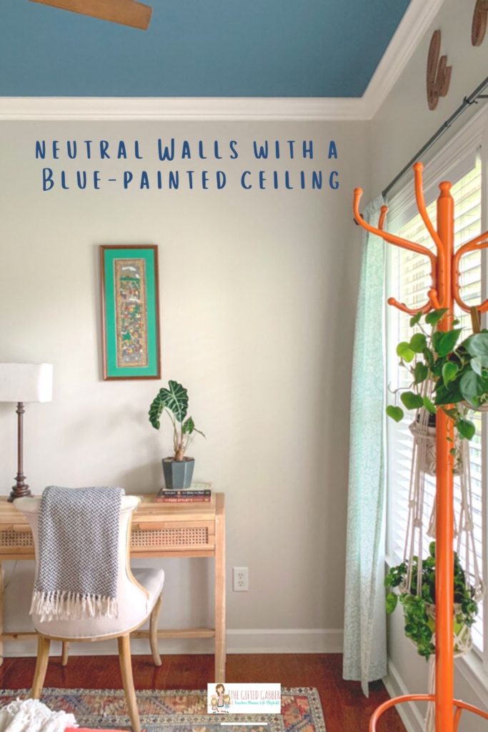 a guest room office combo with plants on a coat tree