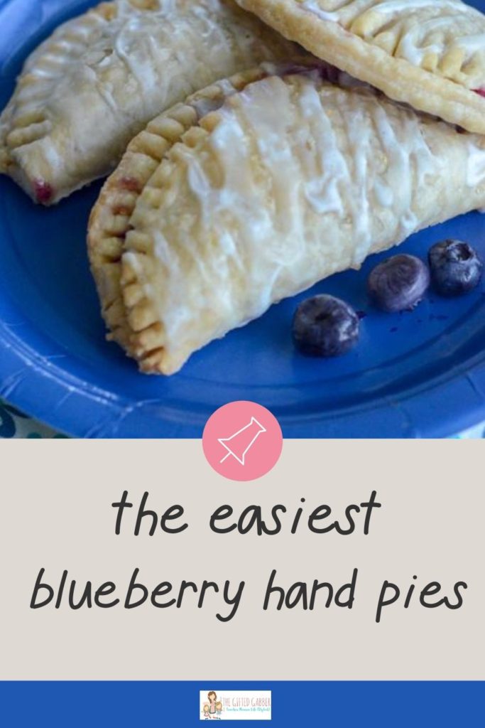 blueberry mini pies on blue plate with blueberries 