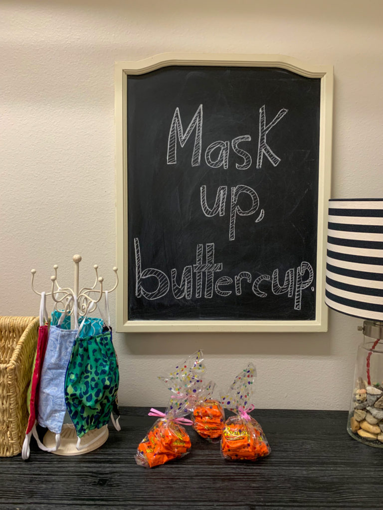 face masks on jewelry stand with Mask Up, Buttercup chalkboard art