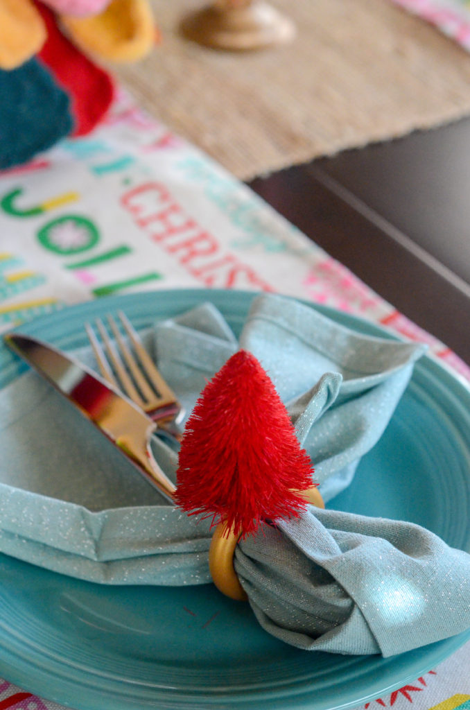 red Christmas tree napkin ring on plate 