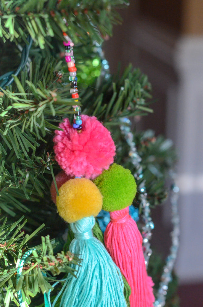 pom pom Christmas tassel ornament hangs on boho Christmas tree