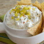 cold chip dip from a dill pickle dip recipe in white bowl with tortilla chips