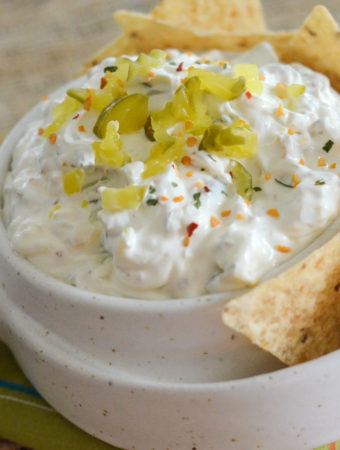 cold chip dip from a dill pickle dip recipe in white bowl with tortilla chips