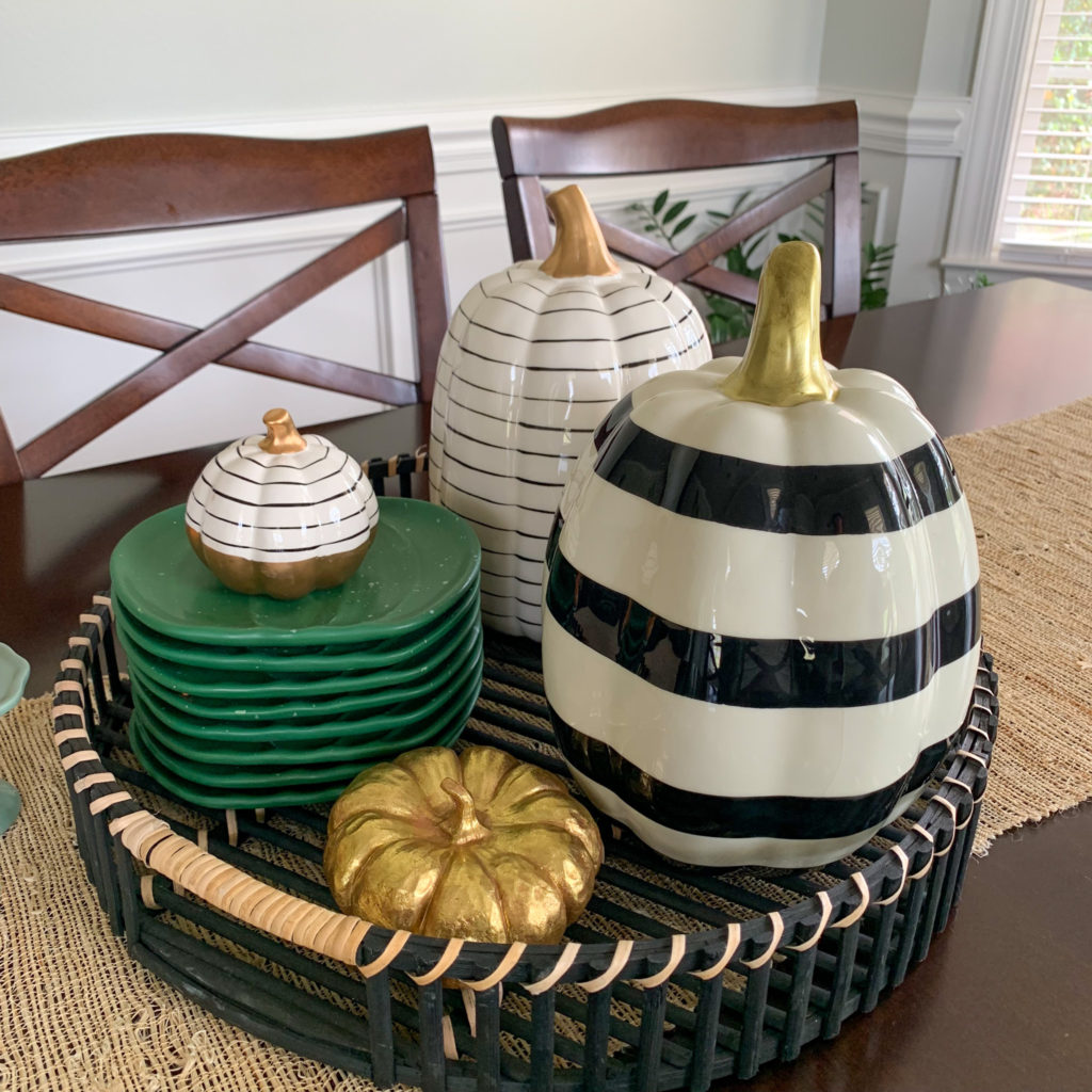 black and white ceramic pumpkins in basket serving as fall decorations for home dining room