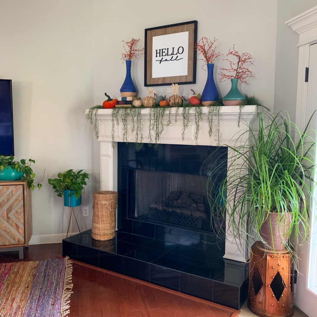 fall decorations for home mantle with live plants flanking both sides 