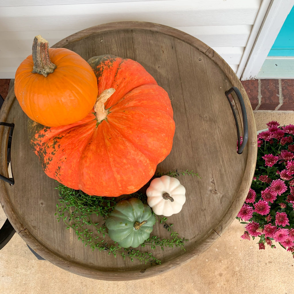 overhead view of stack of vibrant pumpkins on fall porch