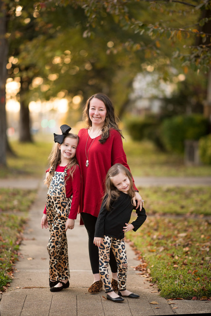 mom and daughters pose in red and leopard print outfits in family pictures in Benton, Arkansas