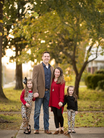 family poses in leopard outfits on tree-lined street in Benton, Arkansas
