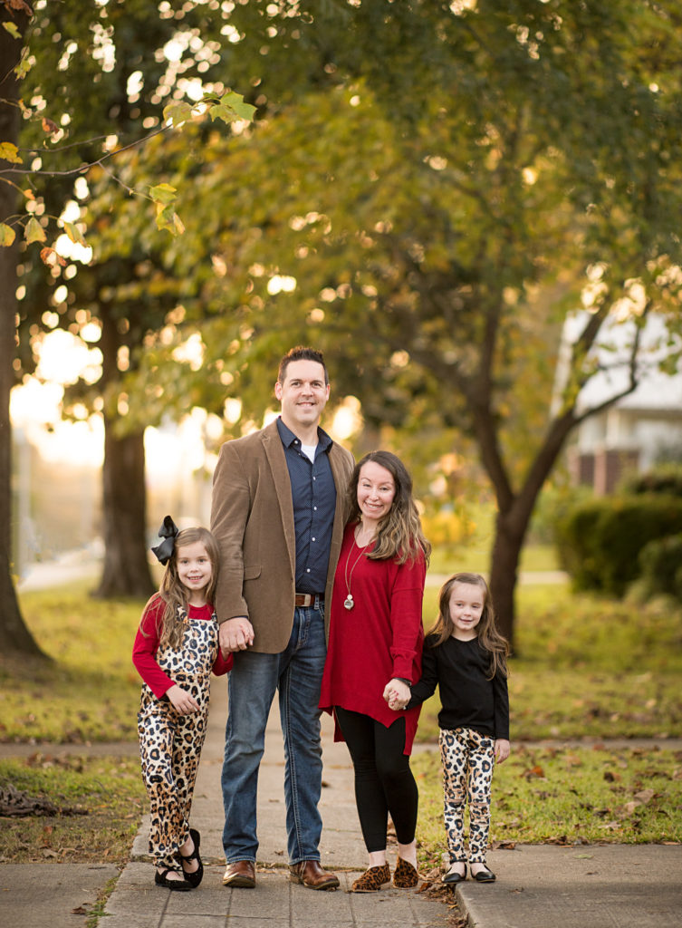 family poses in leopard outfits on tree-lined street in Benton, Arkansas