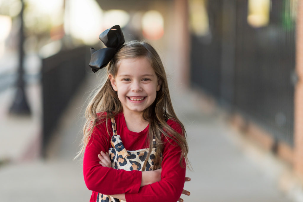 little girl in leopard outfit poses in downtown Benton, Arkansas