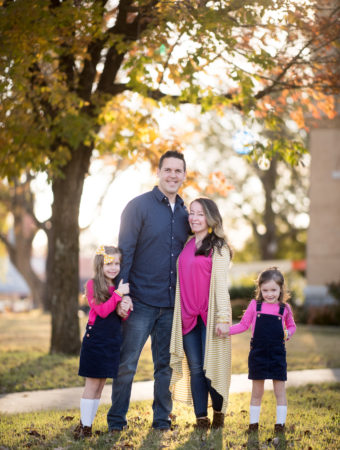 family of four in navy and pink outfits for family pictures