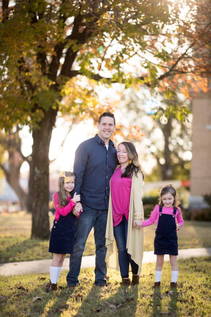 family of four in navy and pink outfits for family pictures