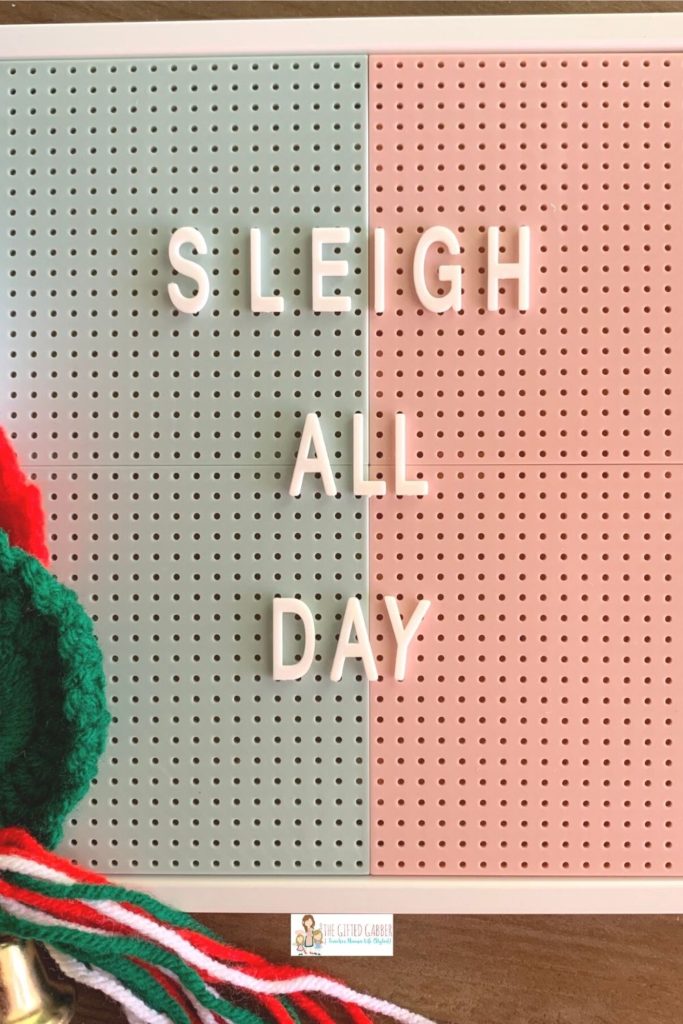 Sleigh All Day message on a green and pink peg board