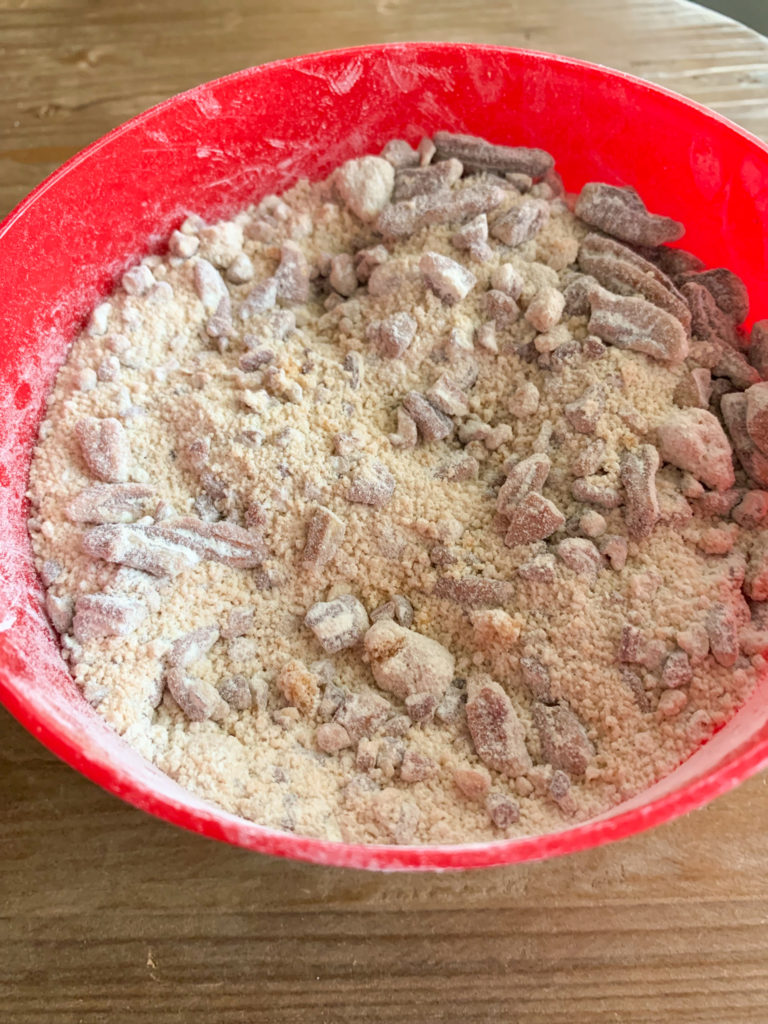 red mixing bowl of pecan streusel topping 