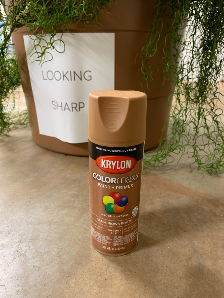 terra cotta spray paint can in front of bucket