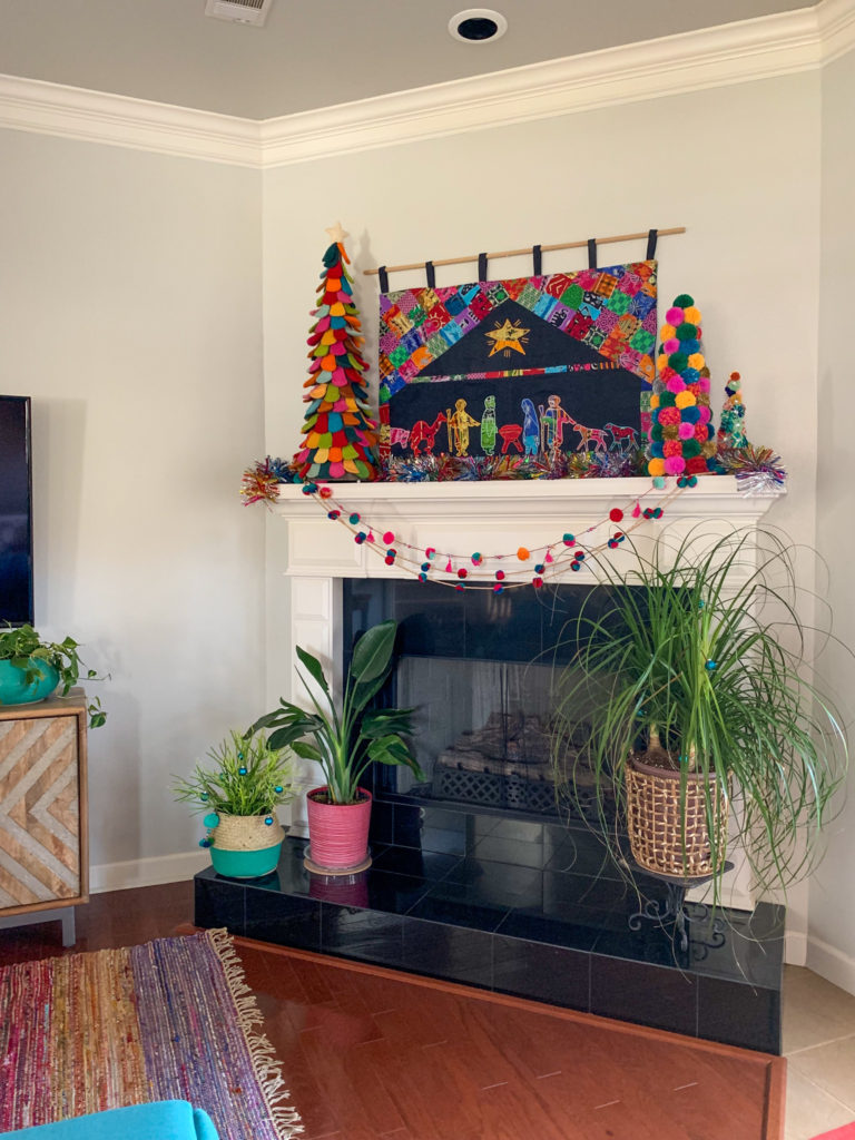 pom pom Christmas decorations with an African Nativity tapestry