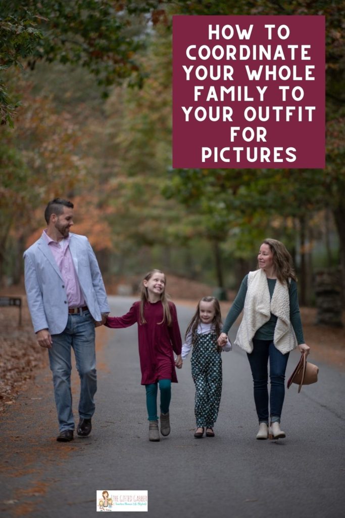 family walks in Wildwood Park for the Arts in Little Rock while wearing teal and maroon outfits