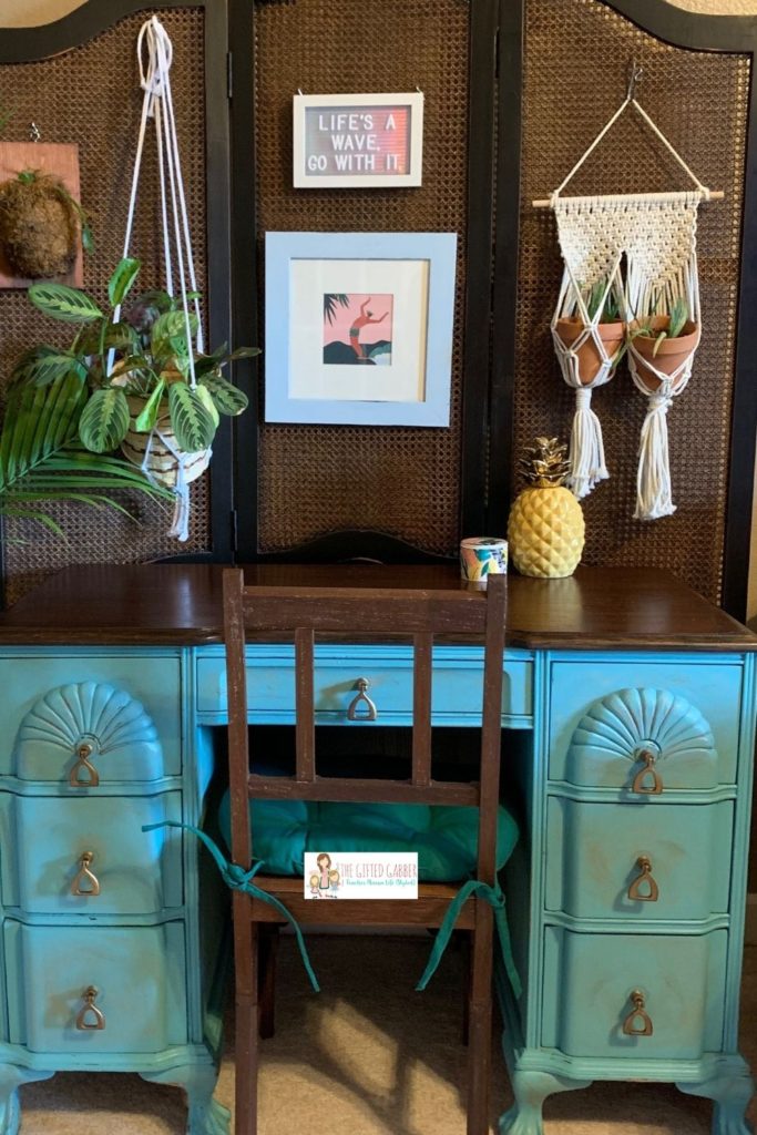 turquoise desk with surfer art and quotes on beach life and palm trees quotes on letter board with artwork