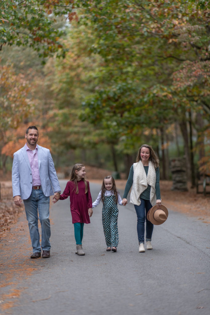 Arkansas lifestyle blogger, Amy, and her family wear dark teal color outfits while walking in Wildwood Park for the Arts in Little Rock