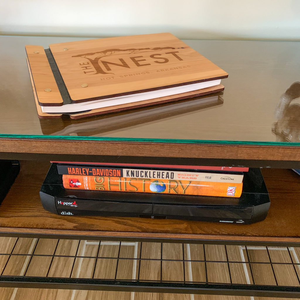 wooden guest book on TV console
