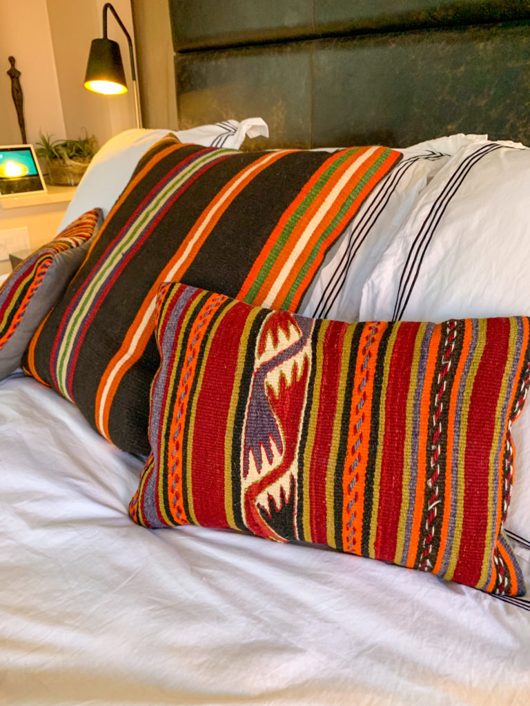 colorful pillows on white bed