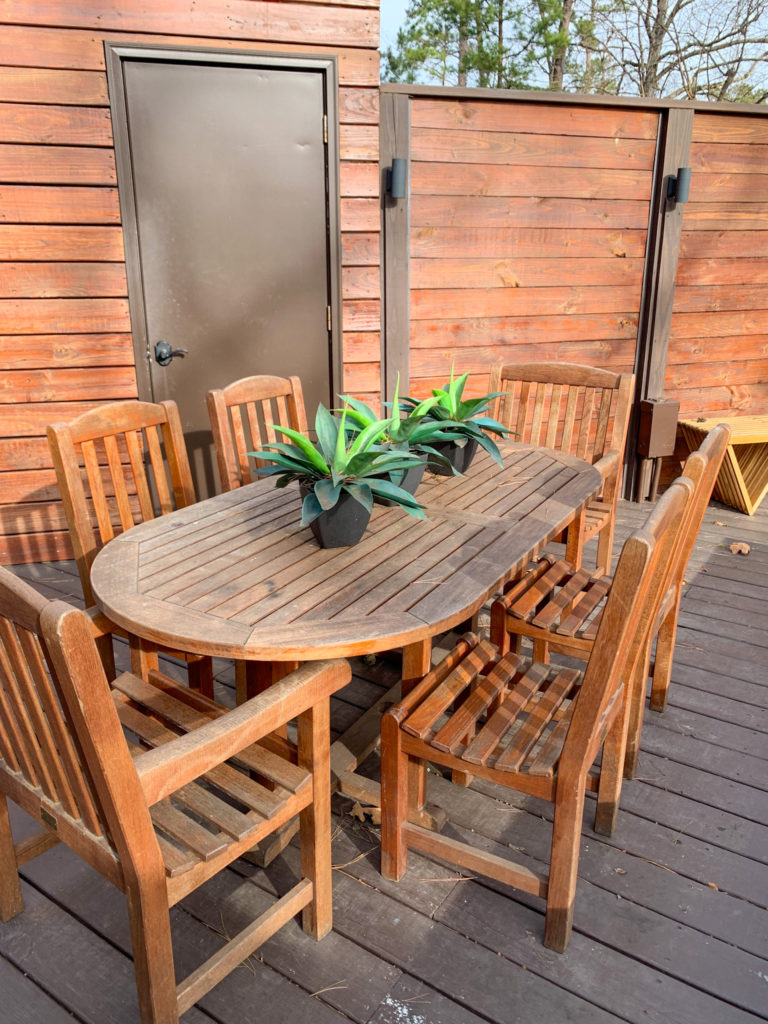 outside dining table and chairs on deck surrounding a luxury tent vacation rental in Hot Springs, Arkansas