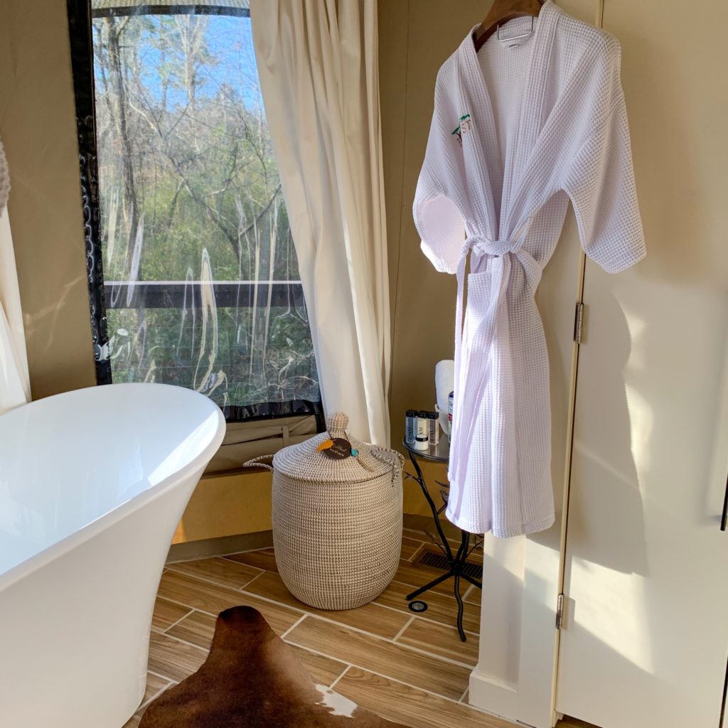 white robe hangs in bathroom of luxury tent in Hot Springs