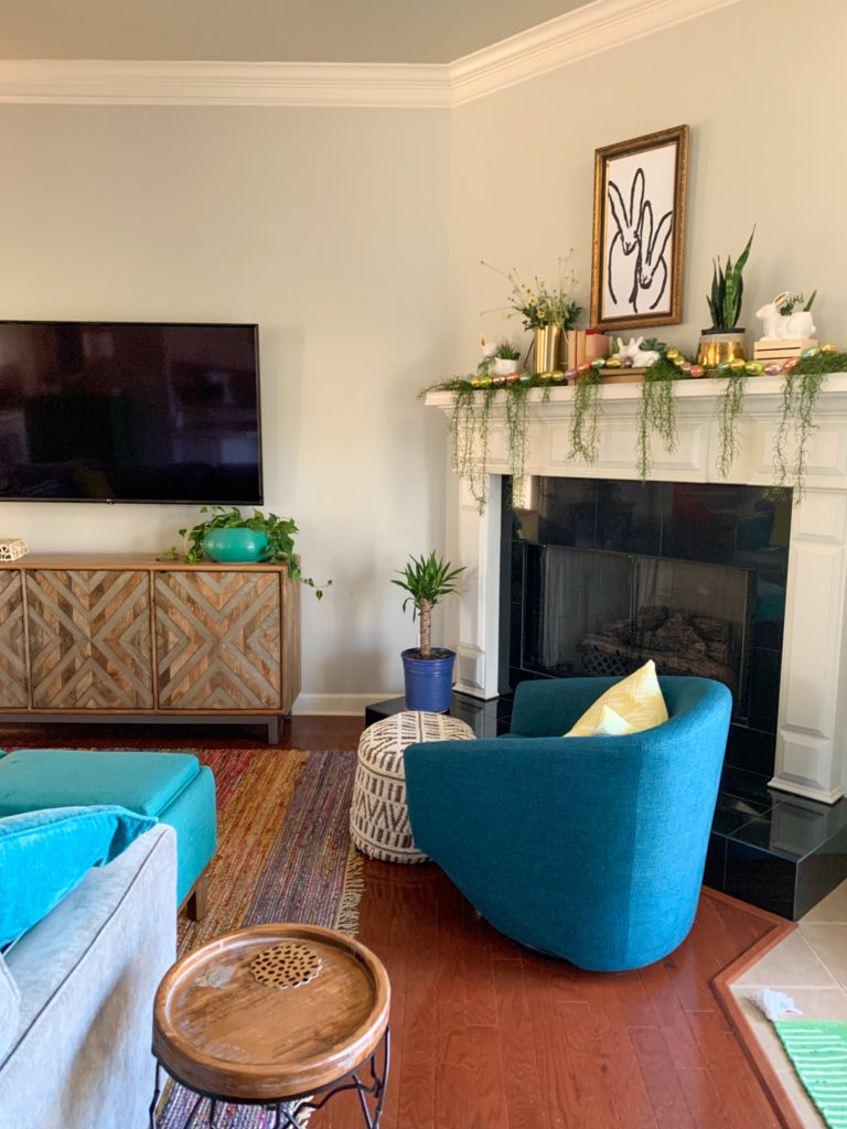 blue chair and Easter rabbit decor on mantle in living room