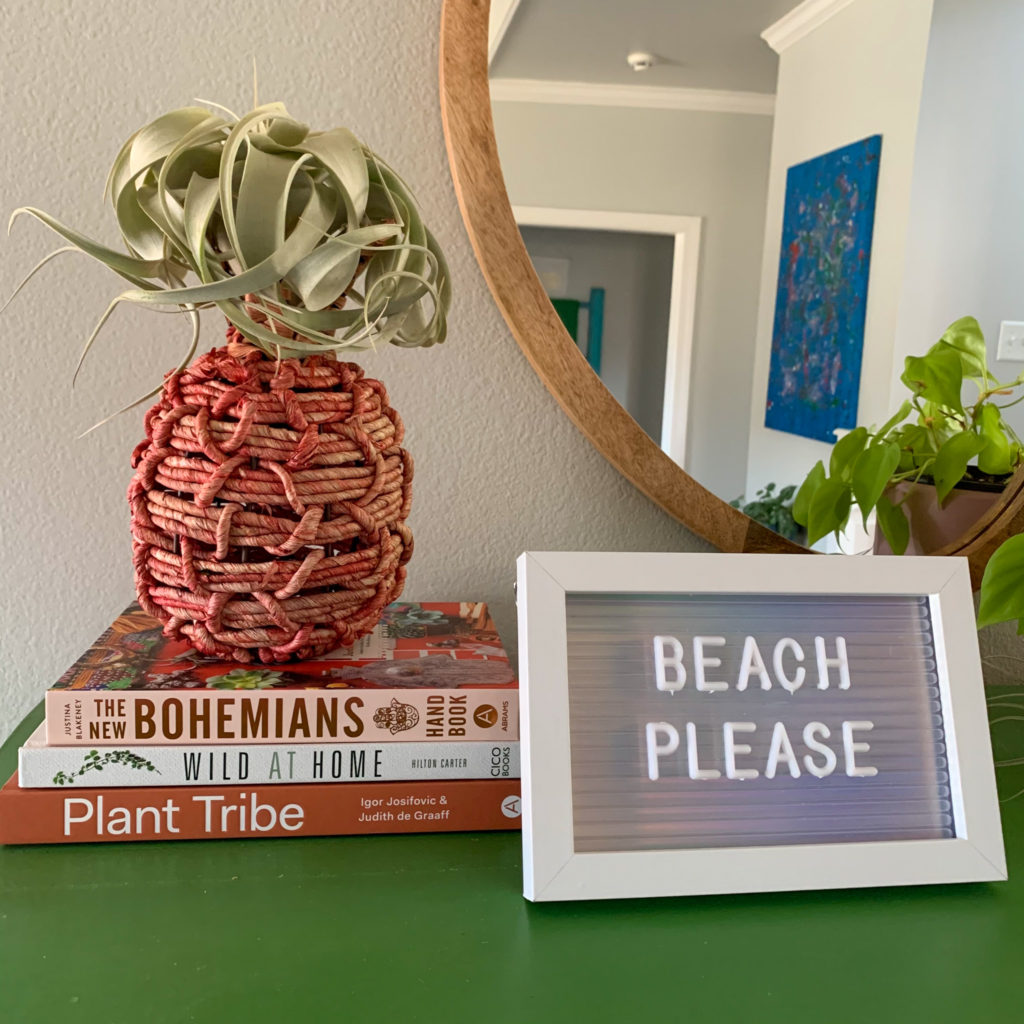 "Beach Please" witty and inspiring beach quote for letter board with pineapple and zerographica air plant and stack of plant books with mirror reflected in background 