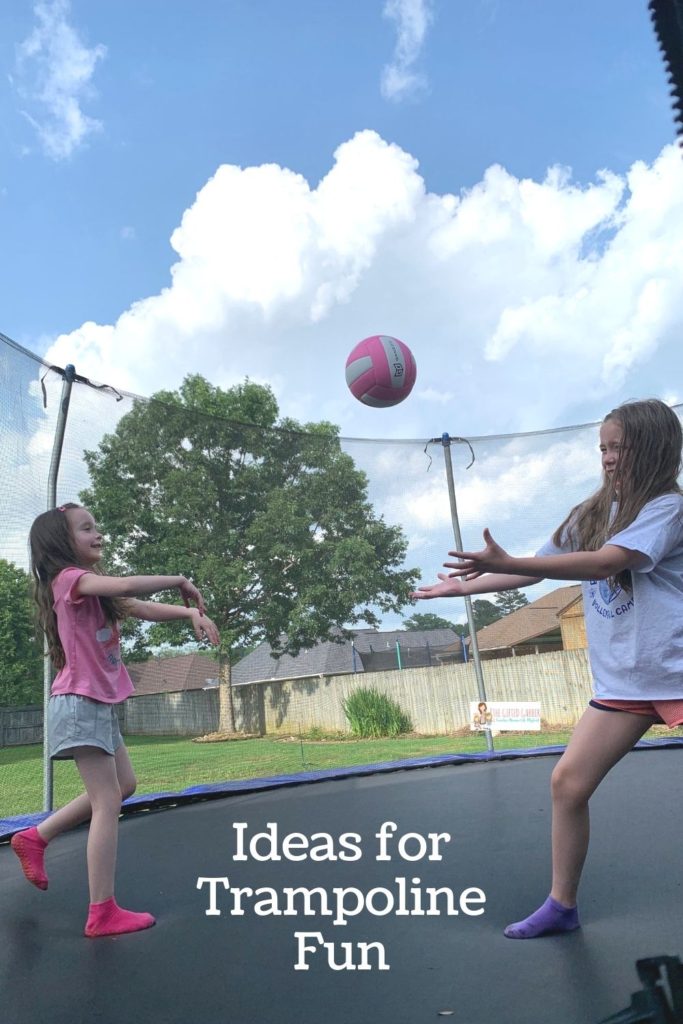 kids having trampoline fun with trampoline ball on a 17x10 oval trampoline with net in backyard