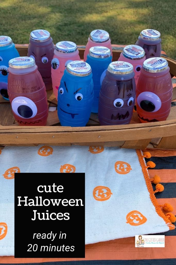 Halloween juice boxes in a wooden tray on a Halloween table with a text overlay 