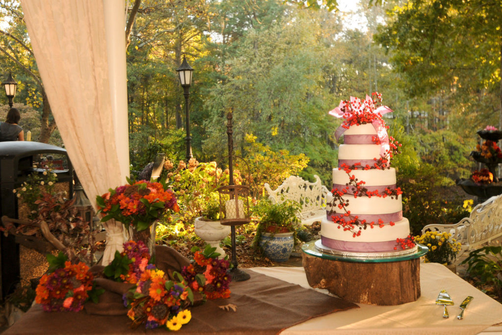 a beautiful wedding cake with berries on display at one of the top Little Rock Arkansas wedding venues - Alda's Magnolia Hill