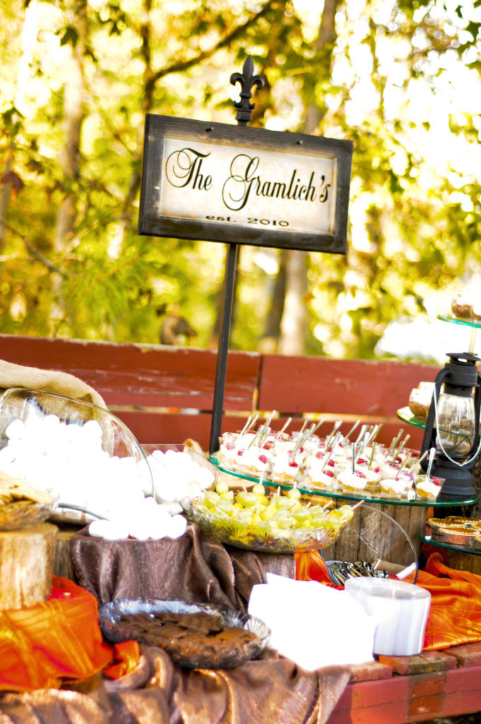 wedding dessert bar with miniature desserts and a family name sign during an Arkansas wedding at Alda's Magnolia Hill 