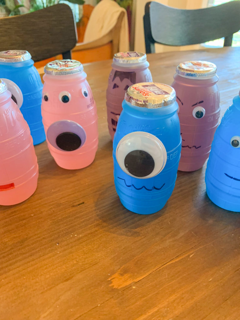 a group of Hug juice barrels with googly eyes and faces for Halloween juice boxes for kids