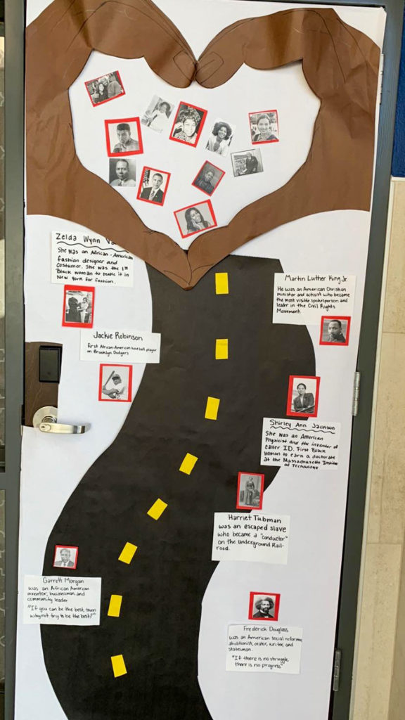 a classroom door decorated for Black History Month with a road and a heart featuring famous Black Americans