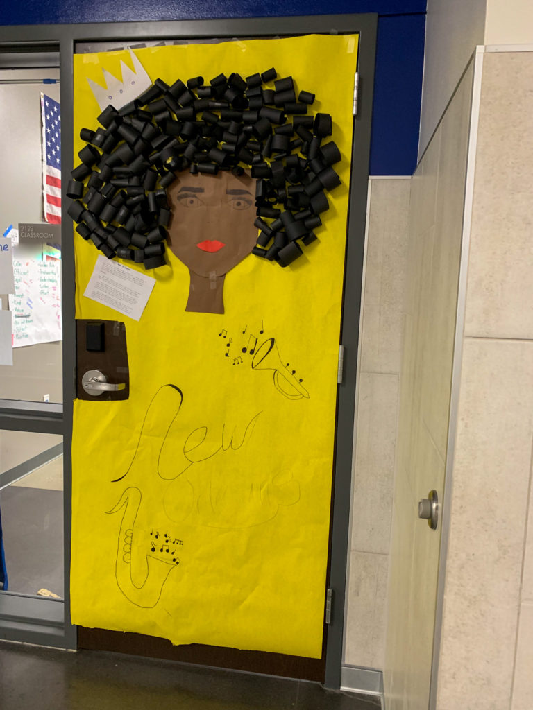 Black History Month door decorated with a New Orleans music theme with lady's face on yellow paper