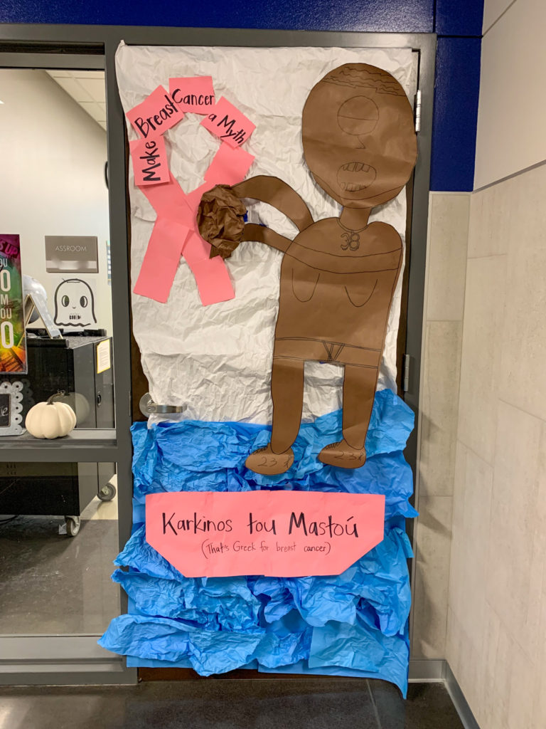 an English classroom door decorated with Greek mythology character for Breast Cancer Awareness Month contest