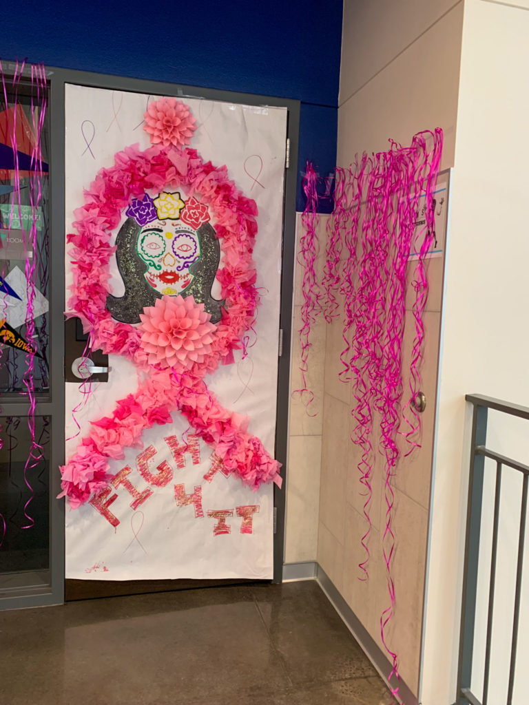 a decorated office door with Breast Cancer Awareness Month decorations and Hispanic Heritage Month decorations