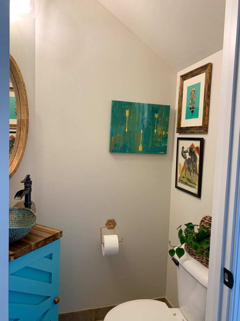 the after shot of a small powder room update with a vessel copper sink and custom vanity