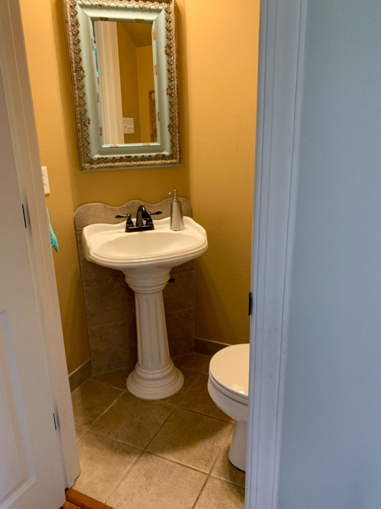 the before image of a 2 piece bathroom before a small powder room update