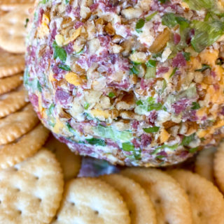 cheese ball with dried beef surrounded by crackers