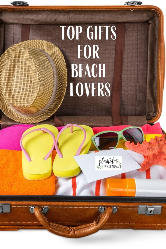 suitcase of beach accessories with text overlay of best gifts for beach bum