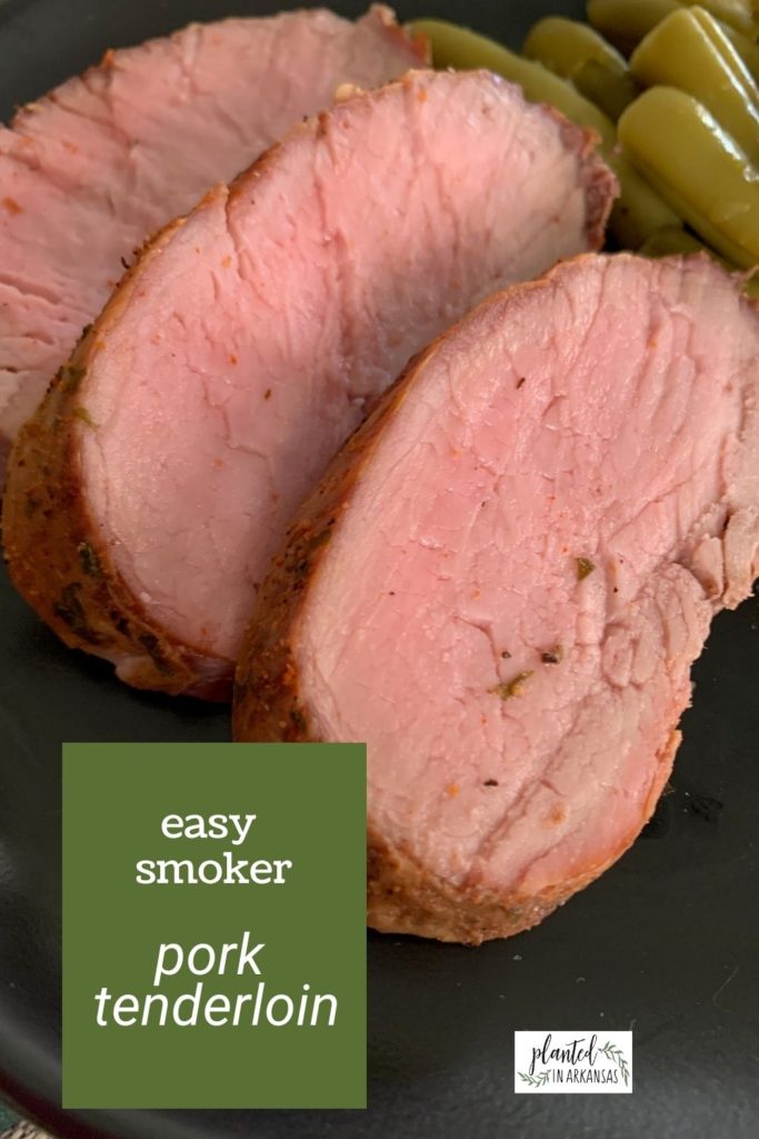 medium smoked pork tenderloin on a black plate with green beans and text overlay