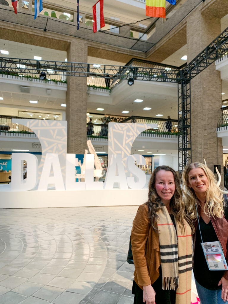 Arkansas lifestyle blogger, Amy, with her friend at Dallas Market Hall during Dallas Market week with ideas on what to wear to Dallas Market