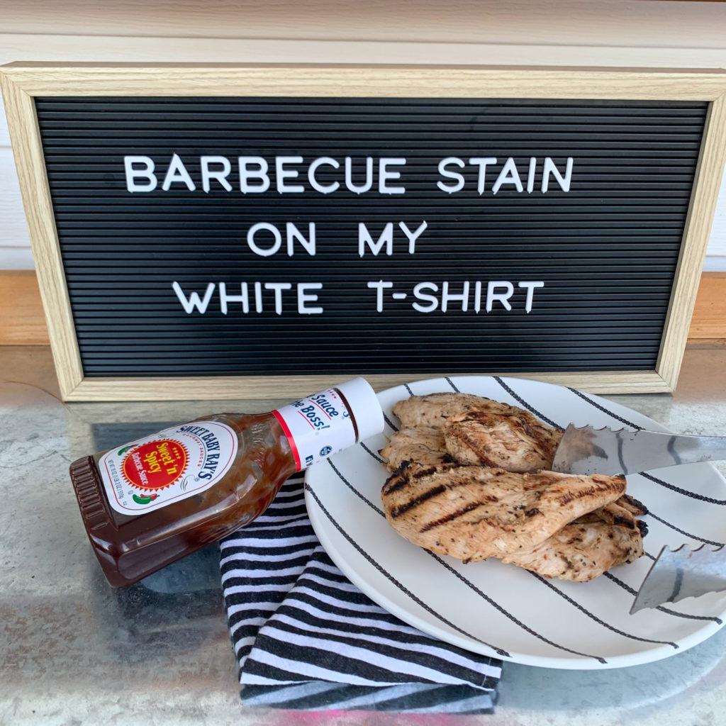 bbq puns on black letter board with plate of grilled chicken and bottle of bbq sauce (funny cooking quotes)