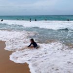 little girl on beach in Condado Beach with gifts for beach lovers