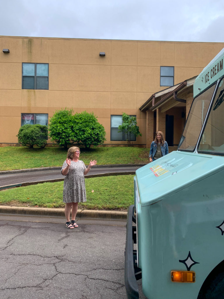woman stands in front of Loblolly ice cream truck rental at her teacher retirement ice cream truck party
